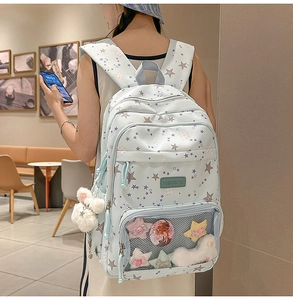 Blue star pattern backpack detail with plush bunny keychain and transparent mesh pocket