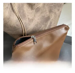 Close-up of premium silver metal zipper on a brown textured leather bucket bag