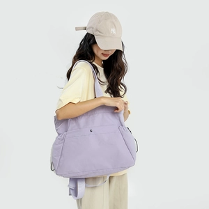 Close-up of light purple water-resistant nylon tote bag with metal button detail