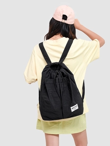 Fashionable black drawstring backpack for women featuring large capacity and waterproof nylon fabric