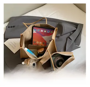 Detail view of khaki tote bag interior showing large capacity for iPad and cosmetics