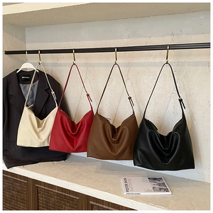 Macro view of textured leather hobo bags in four colors with adjustable metal buckle straps