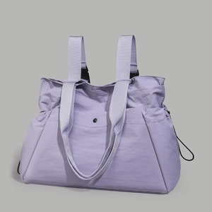 Detailed view of lavender waterproof nylon tote bag with adjustable straps and side pockets
