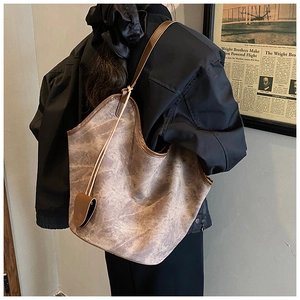 Model view of large marble texture tote bag with slim brown shoulder straps