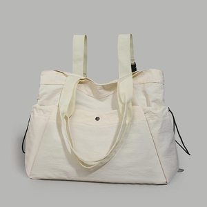 Detail of off-white waterproof tote backpack with adjustable drawstring and metal snap