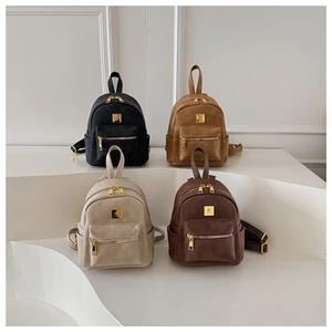 Detailed close-up of retro mini backpacks in black, tan, grey, and brown with gold zippers