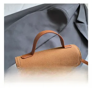 Close-up of comfortable handle detail on brown vintage matte suede crossbody bag