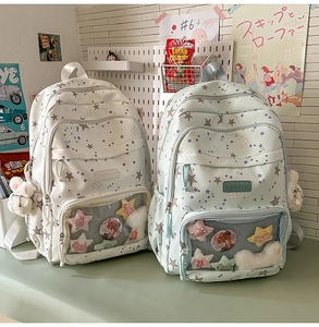 Close-up of student backpack featuring transparent window with pins and star pattern