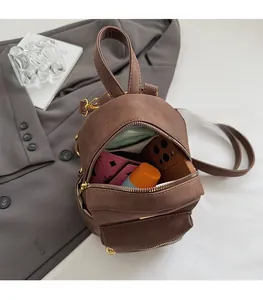 Internal view of the brown frosted mini backpack showing capacity for phone and wallet