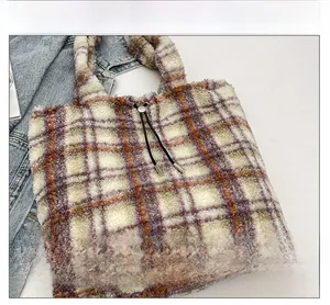 Detail of plush checkered tote bag featuring a purple and orange weave with drawstring buckle