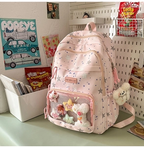 Pink student backpack with star patterns and clear pocket for plush charms