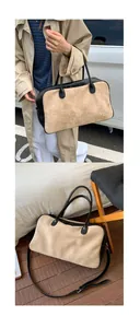 Close-up of contrast beige suede and black leather stitching on a large tote bag