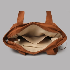 Interior view of large nylon tote bag showing zipper pocket and spacious compartment