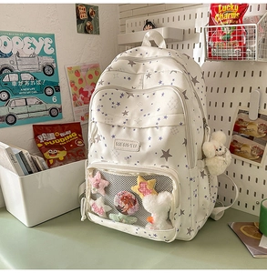 White school backpack with star patterns and clear pocket for badges and charms