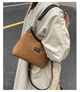 Detail view of the brown vintage suede shoulder bag showing metal hooks and leather trim