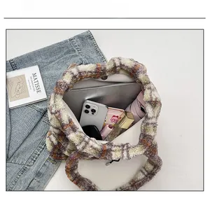 Spacious plaid fleece tote bag showing capacity for laptop and daily essentials