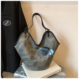 Detail of grey vintage tote bag with scalloped edge and leather glasses holder accessory