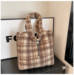 Detailed view of brown checkered faux fur tote bag with plush lamb-like wool texture