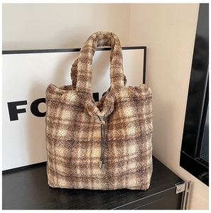 Detail of checkered plush tote bag with brown lamb wool texture and drawstring detail