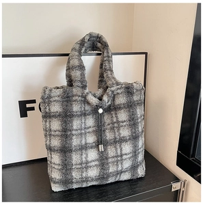 Detail of grey plaid faux shearling tote bag with decorative pearl drawstring closure