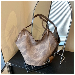 Detail of vintage brown tote bag with deep V-neck opening and leather texture