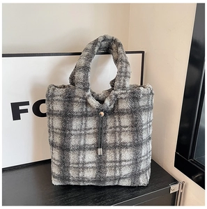 Detail of gray and white checkered faux fur tote bag with stylish drawstring tassels