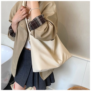 Minimalist cream tote bag with lychee texture shown on model for daily casual commute wear