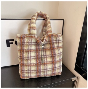 Detail of soft plush plaid tote bag showing fuzzy lamb wool texture and leather drawstring