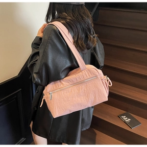 Pink nylon shoulder bag detail featuring functional front zipper pocket and casual style
