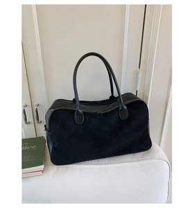 Detail of black suede and leather tote bag with metallic zipper and premium texture