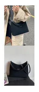 Close-up of retro black canvas and leather stitching tote bag with silver logo detail