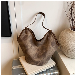 Close-up of vintage tote bag with marble texture and wavy edge on art book prop