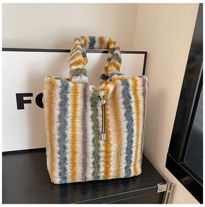 Detailed close-up of fluffy striped plush tote bag with soft texture and metal buckle