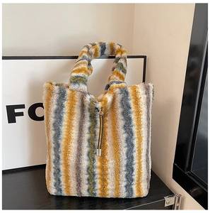 Macro shot of faux fur tote bag showing plush striped texture and metal-tip drawstring detail