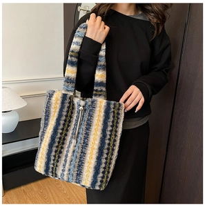 Detail of colorful striped plush tote bag with drawstring and metal buckle closure