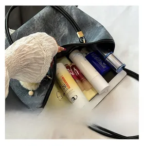 Spacious interior of grey denim tote bag showing capacity for cosmetics and skincare
