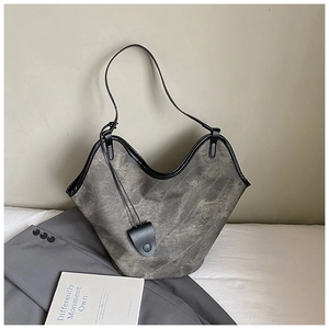 Close-up of retro smoke grey bucket bag with wavy black trim and thin shoulder strap