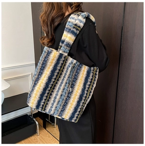 Detail of plush tote bag with blue and yellow stripes and side drawstring tassel