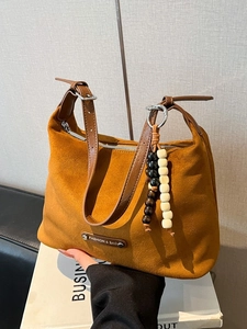 Retro faux suede hobo bag in orange-brown with leather strap and wood bead tassel decoration