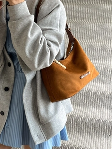 Retro brown suede dumpling shoulder bag with unique wooden bead accents and strap