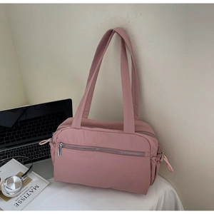 Pink nylon shoulder bag featuring functional front zipper pockets and side drawstrings