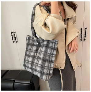 Detail of soft grey and white checkered faux fur tote bag with black drawstring accent