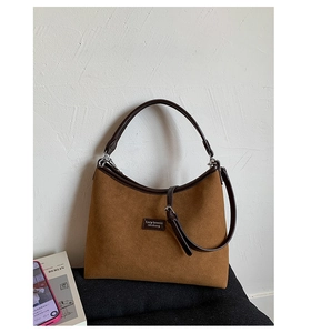 Detail view of brown matte leather shoulder bag with Lazy Breeze branding and shoulder straps