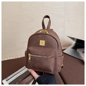 Detail of a brown frosted faux leather mini backpack with golden metal zippers and logo