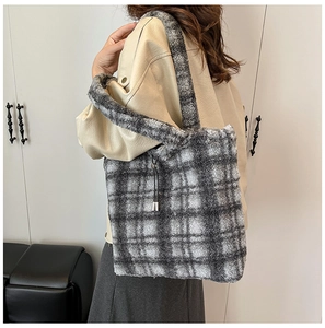 Detail of grey and white checkered faux fur tote bag with plush shoulder strap
