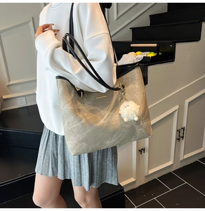 Large capacity gray tote bag with marble texture and plush monster charm detail
