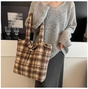 Detail of soft brown and beige plaid faux fur tote bag with drawstring closure