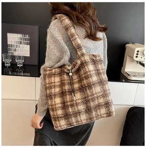 Detail shot of plush brown and beige checkered tote bag showing soft faux fur texture