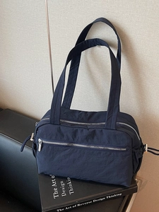 Minimalist navy blue nylon tote bag with multi-pocket design for daily commute