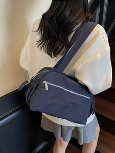 Navy blue large capacity nylon shoulder bag with side pockets and wide straps